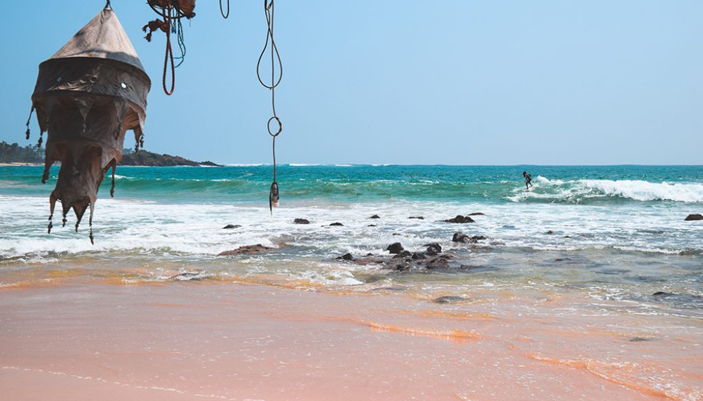 A photo of a surfer at Marissa beach in Sri Lanka near our homestay.